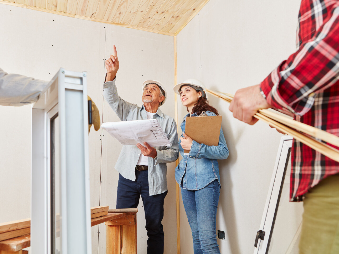 Smart Planning Renovation Checklist Reviewing renovation checklist and architectural drawings with experts on-site