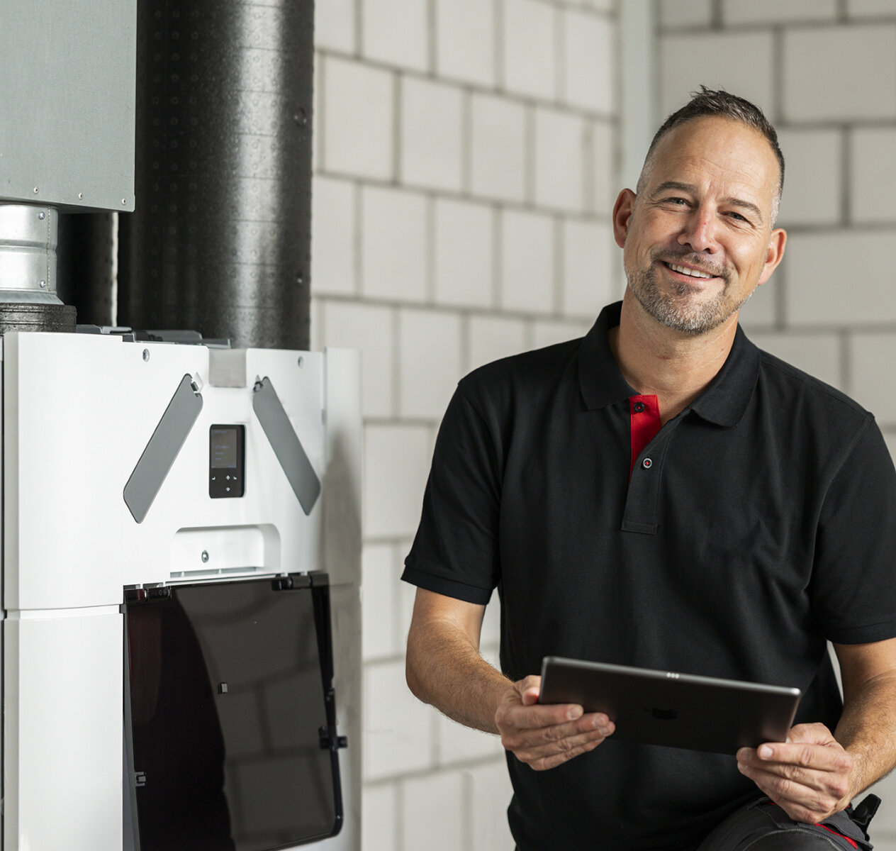 Service-Technician with Tablet smiling before at Comfo-Systems-Unit