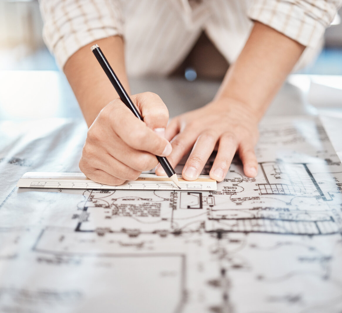 AdobeStock_528828483 Architect drawing building floor plan, design blueprint map and engineer drafting structure on table paper. Real estate development work office construction and industrial wall safety ruler.